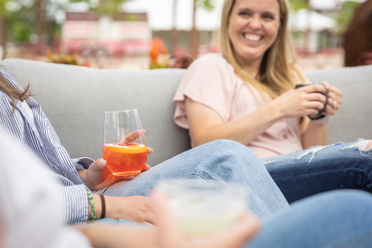 A group of women sipping cocktails on the patio at Helix