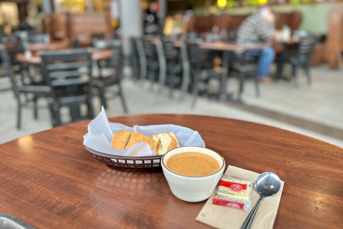 a cup of chicken tortilla soup and a basket of bread at Acoustic Cafe