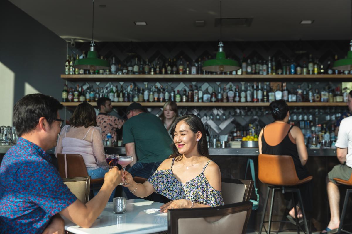 a couple having cocktails at Dive bar in Eau Claire