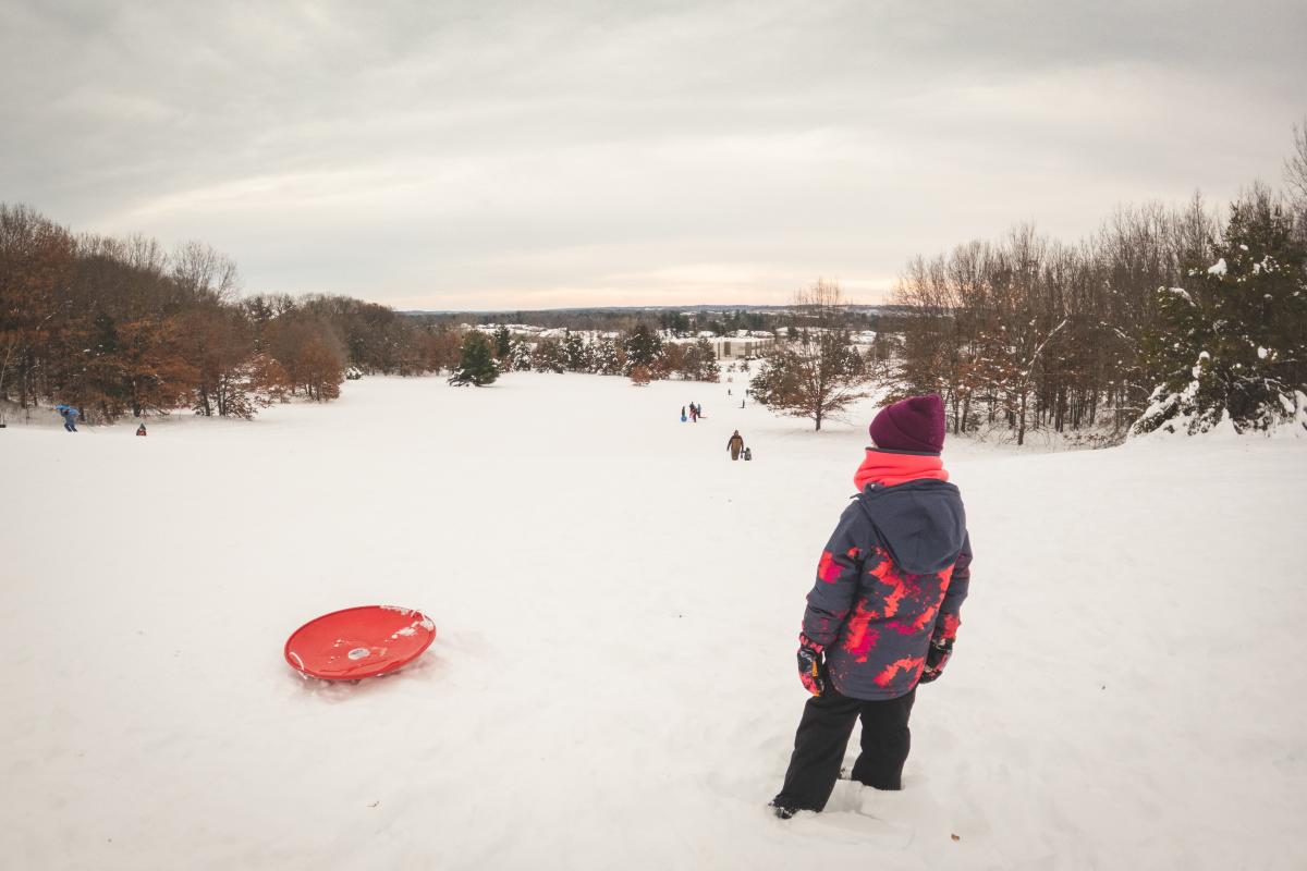 A young girl getting ready to slide down Jelly Bean Hill in Altoona, WI