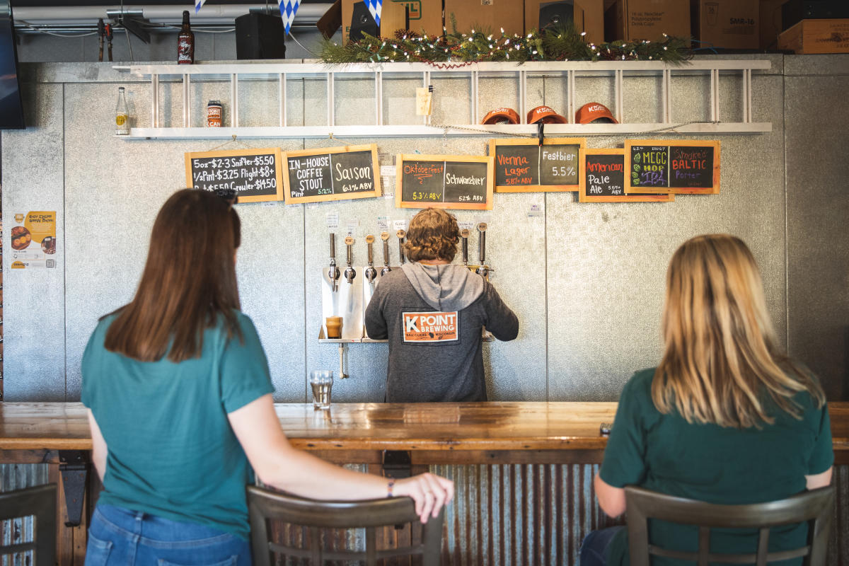 Two women waiting at the bar for their beer at K Point Brewing in Eau Claire, WI