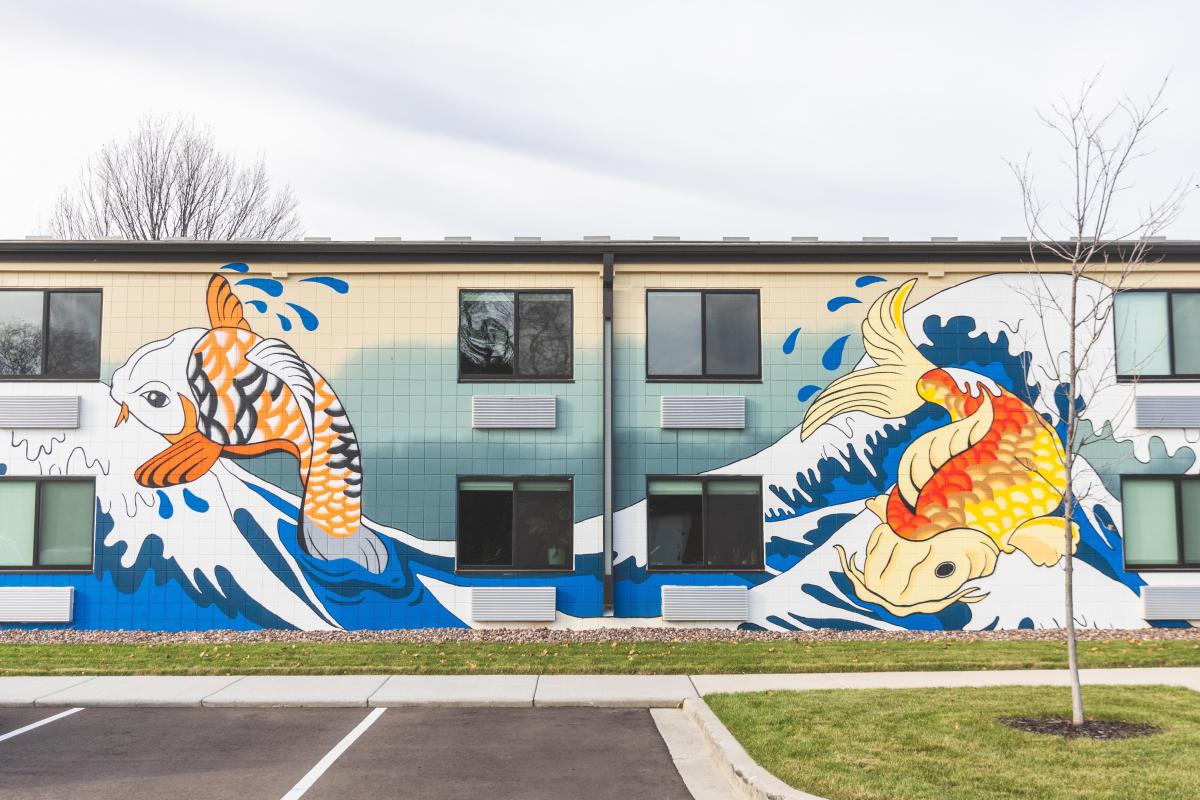 A mural of two koi fish on the side of an apartment building