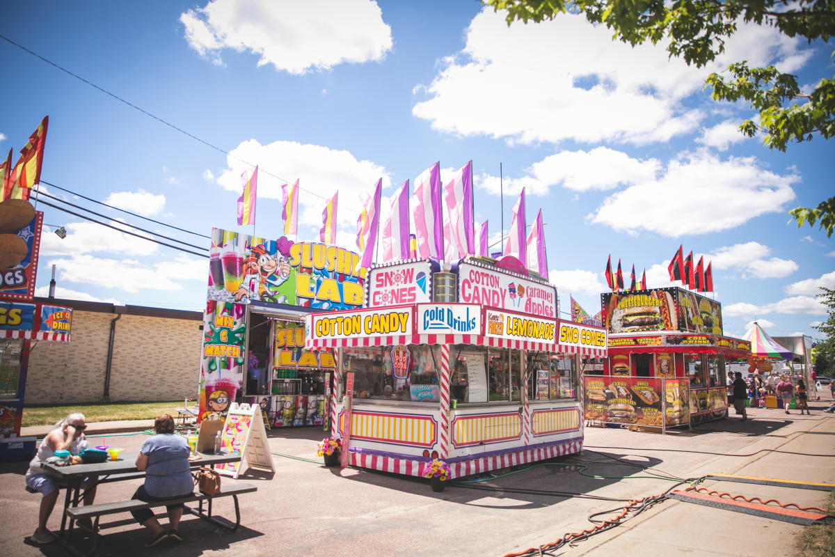 A street filled with carnival food vendors at Lake Martha Days