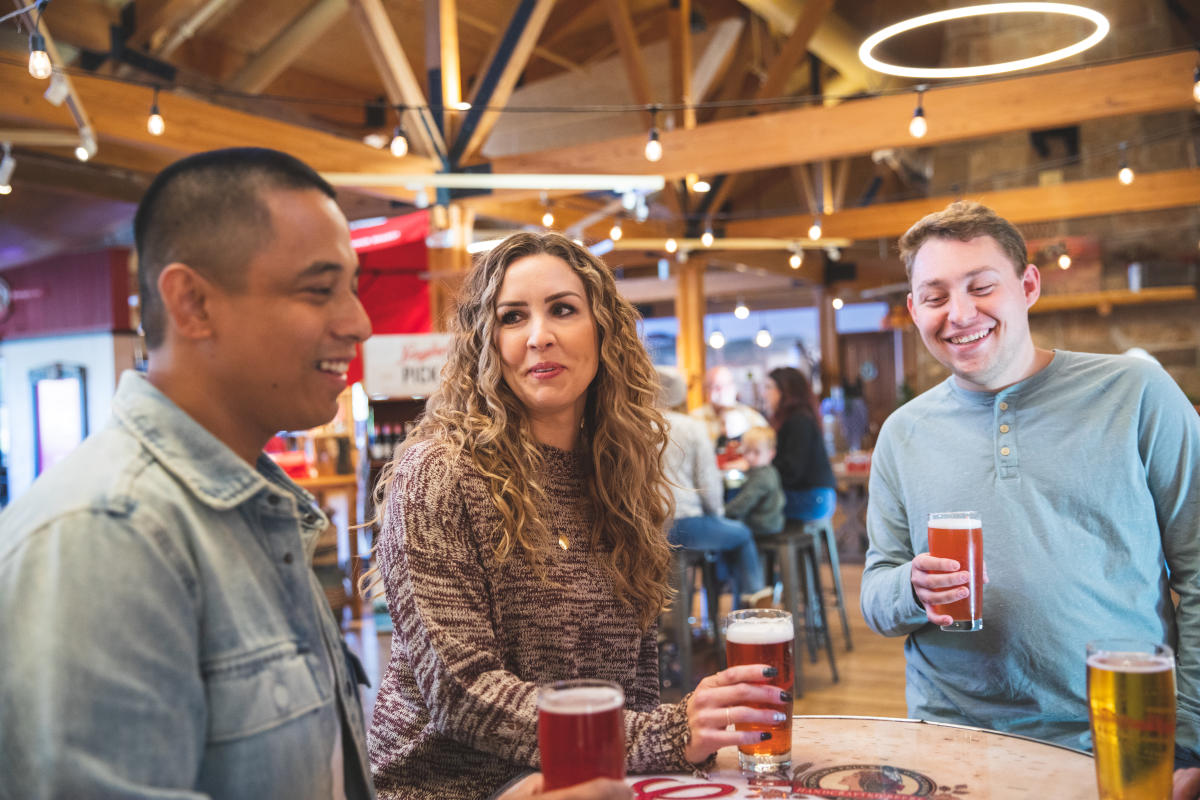 A group of three enjoying pints of beer at the Leinie Lodge