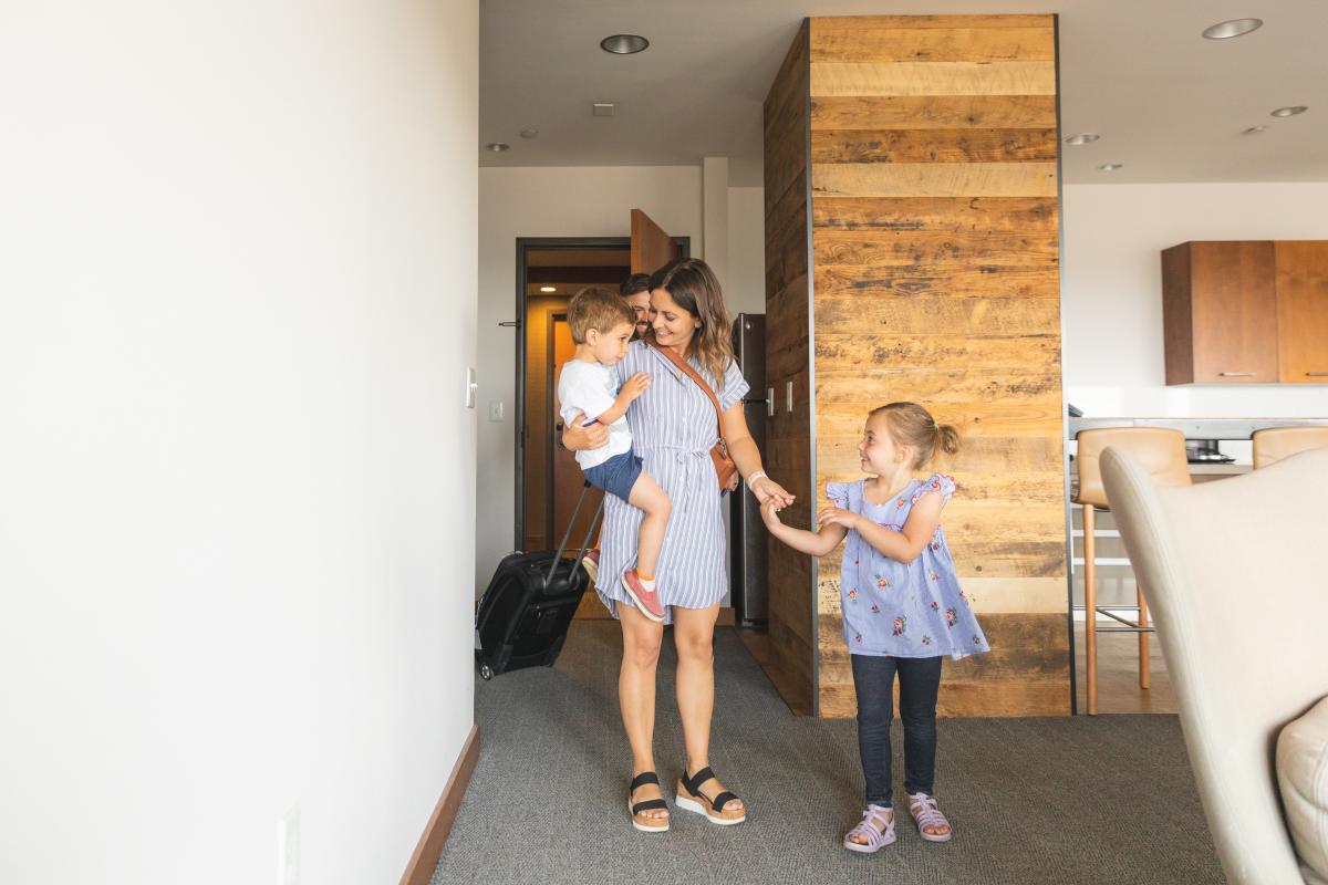 A family walking into a hotel room at the Lismore Hotel