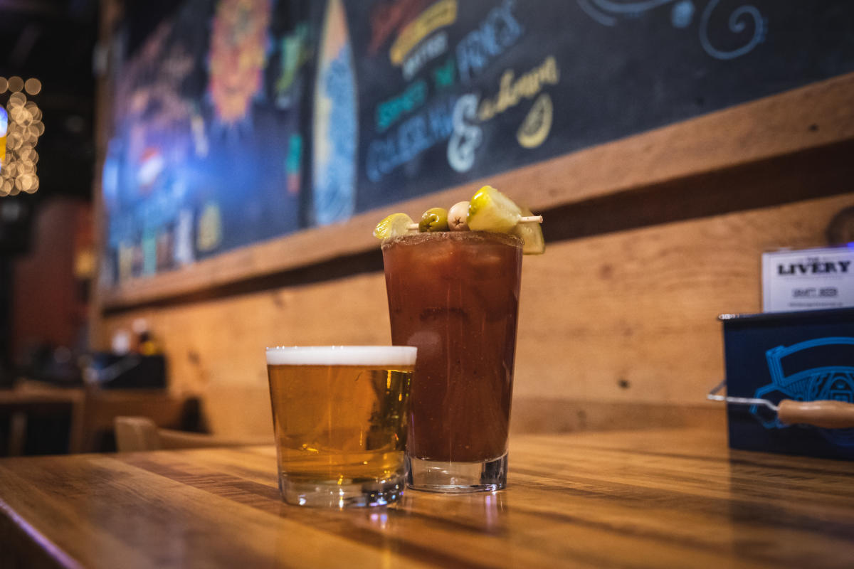 A Bloody Mary served with a beer chaser, lemon, olives, and a pickle at The Livery