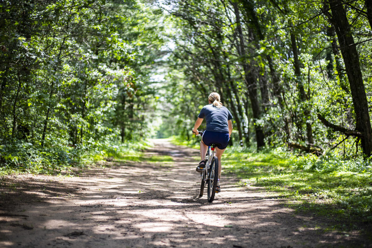 Woman mountain biking on trail at Lowes Creek