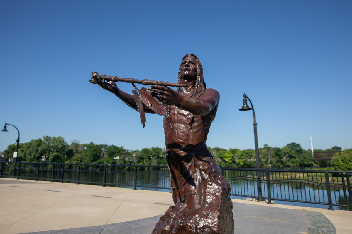 A sculpture of a Native American on Haymarket Plaza near the confluence