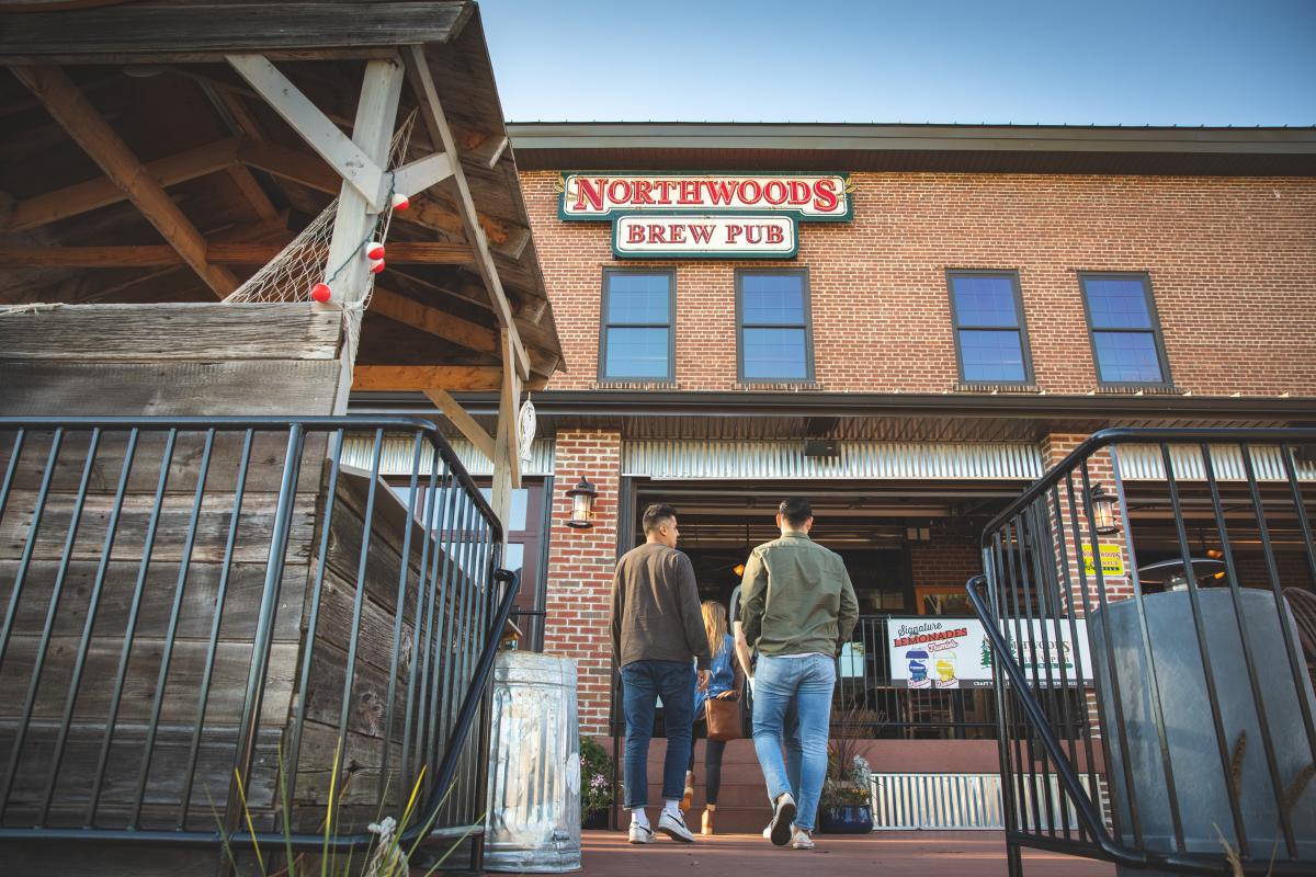 A group of people walking into Northwoods Brew Pub