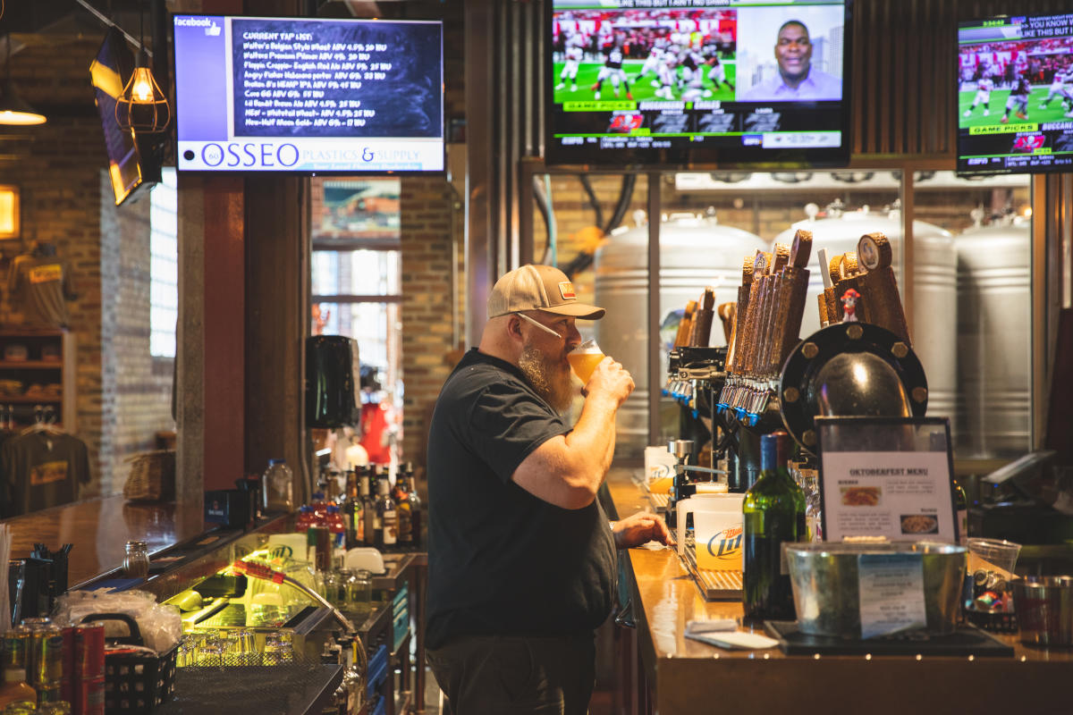 The bartender sipping a pint beer at Northwoods Brewpub in Osseo