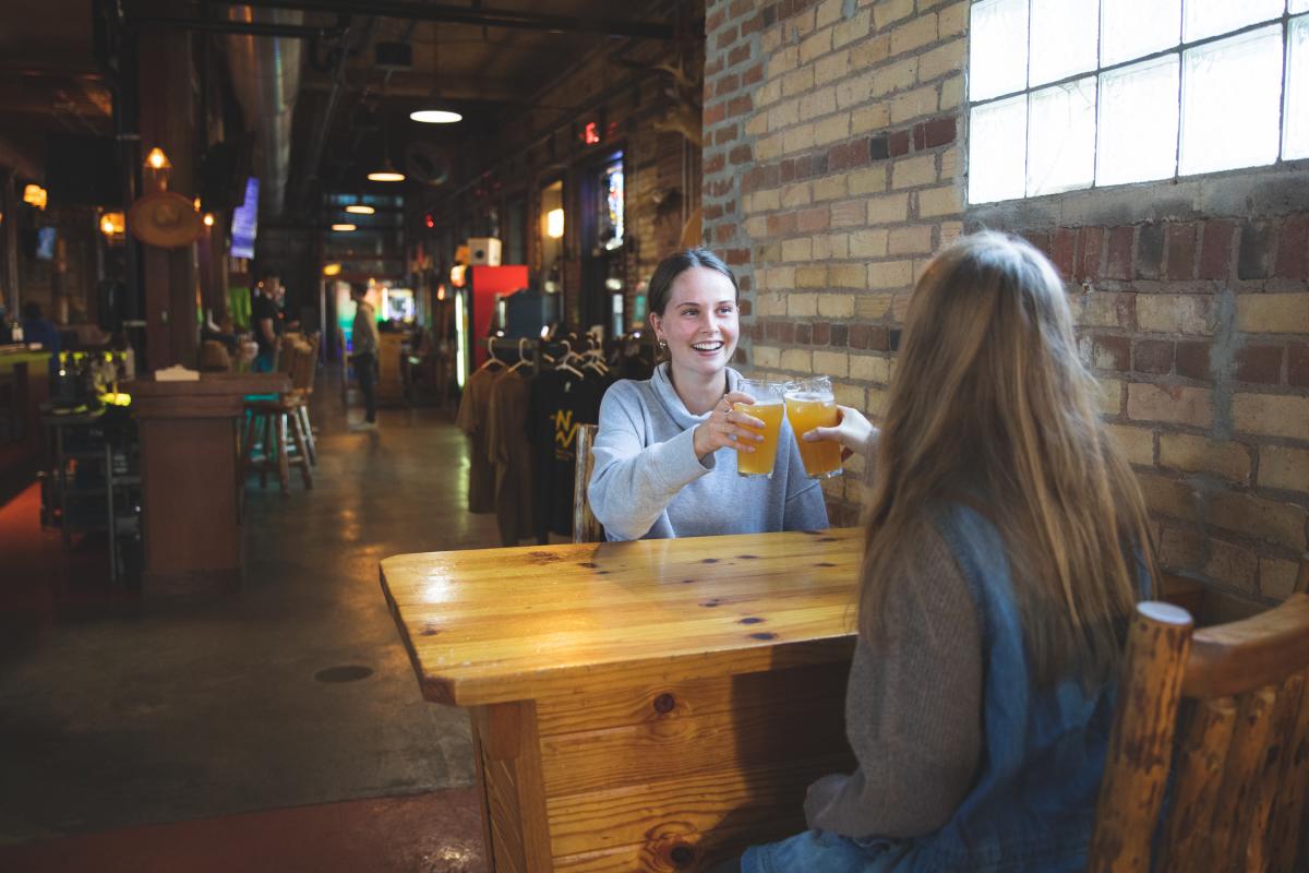 Two girls cheers their beers at Northwoods Brew Pub in Osseo, WI