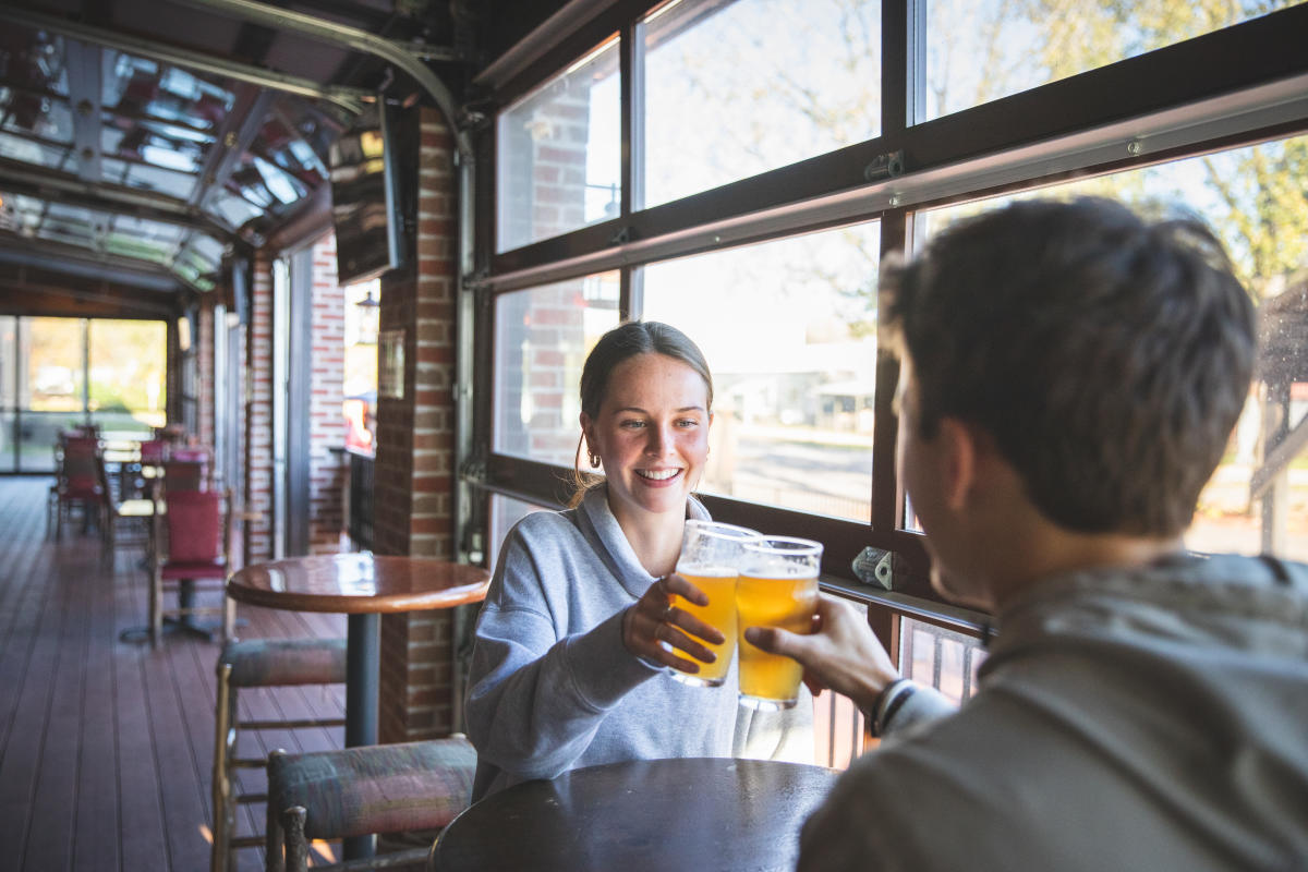 A couple "cheers" their beer at Northwoods Brew Pub in Osseo