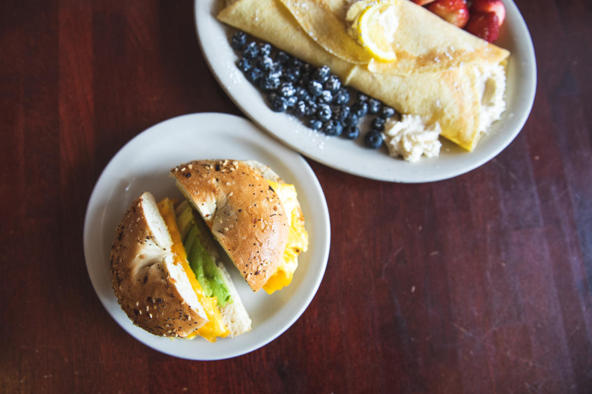 a bagel sandwich and a crepe with fruit at The Nucleus Cafe