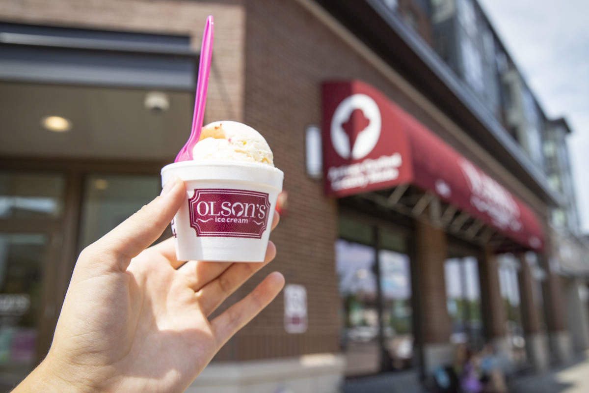 Holding up ice cream in front of Olson's in downtown Eau Claire