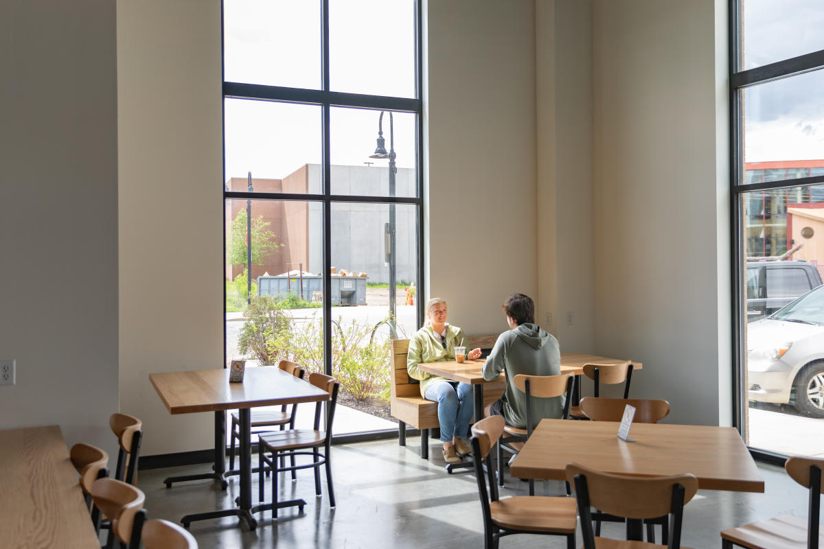 Two people having coffee at a table at Phoenix Coffee