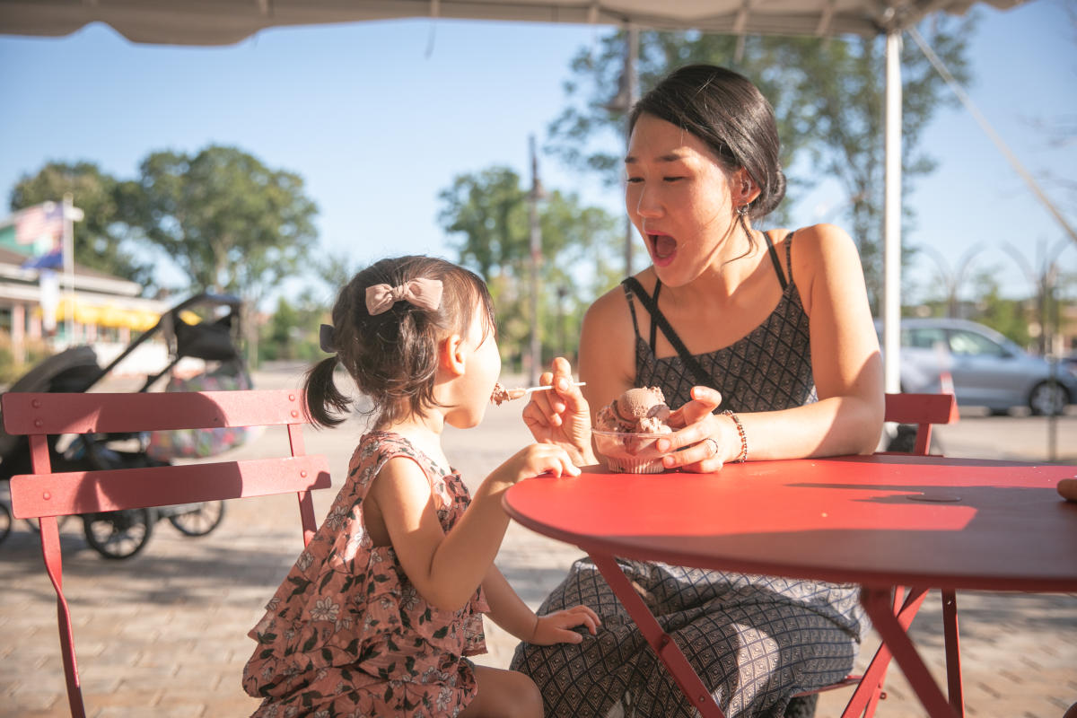 A young girl and her mom eating ice cream from 44 Below outside at River Prairie in Altoona, WI