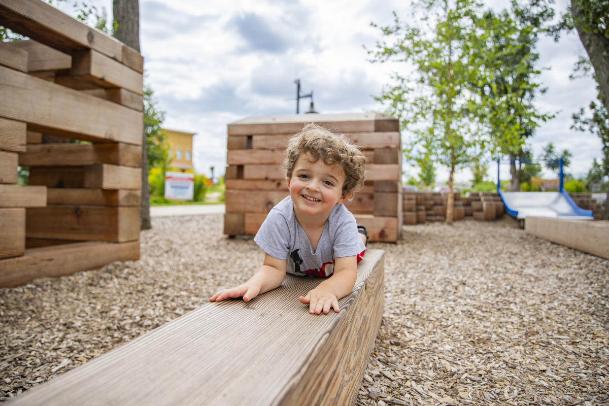 Little boy playing on the playground at River Prairie