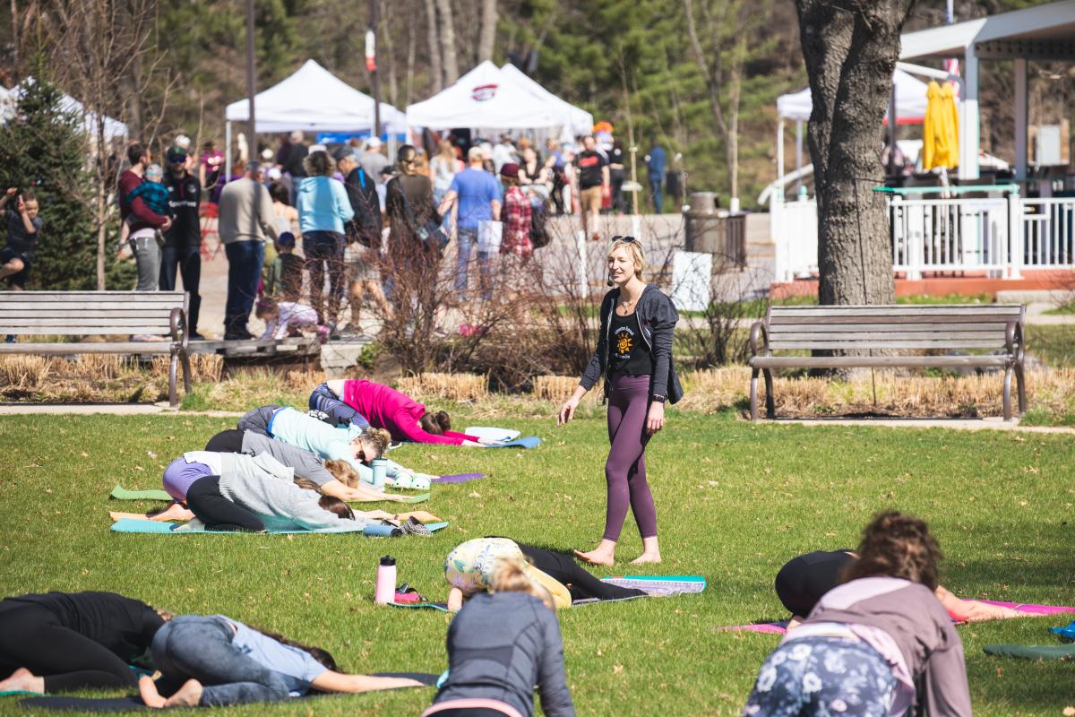 A group of people doing yoga outside at the River Prairie Festival in Altoona, WI