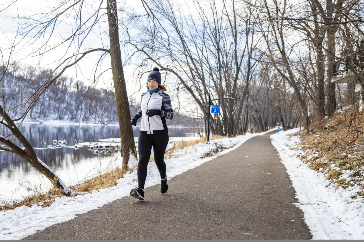 A woman running in winter gear on the Winter Route