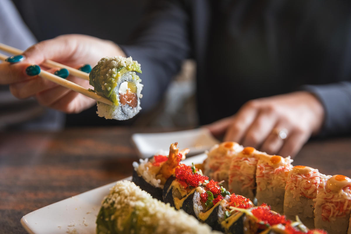 Sushi being picked up with chopsticks at Shanghai Bistro in Eau Claire, WI