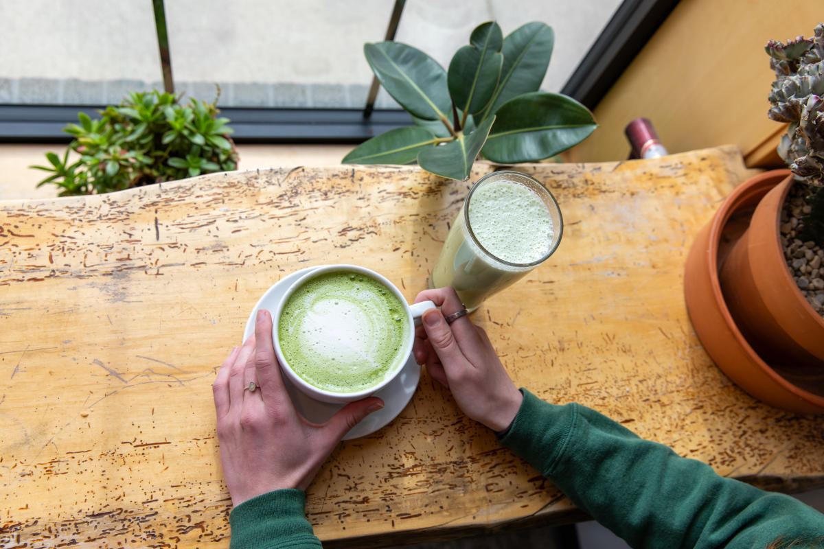 A hand holding a matcha at Shift