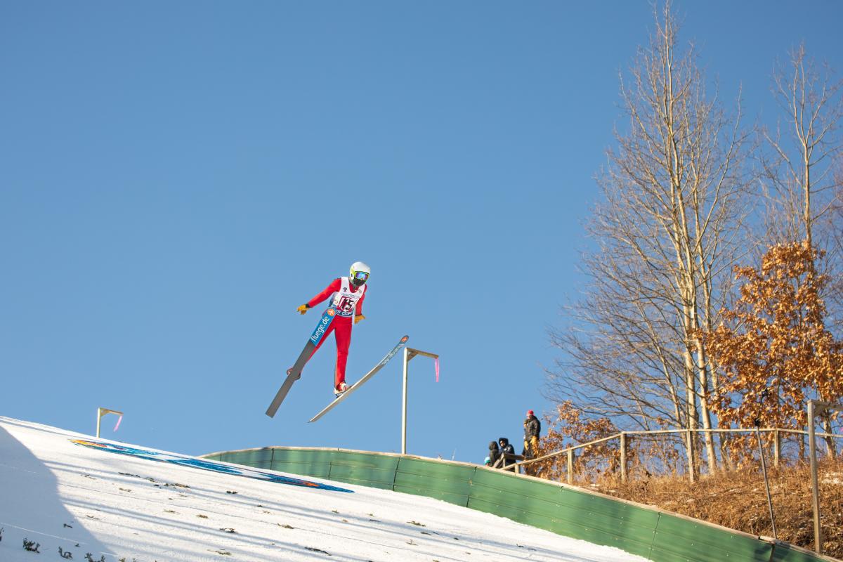 A ski jumper flying through the air at Silver Mine Ski Invitational