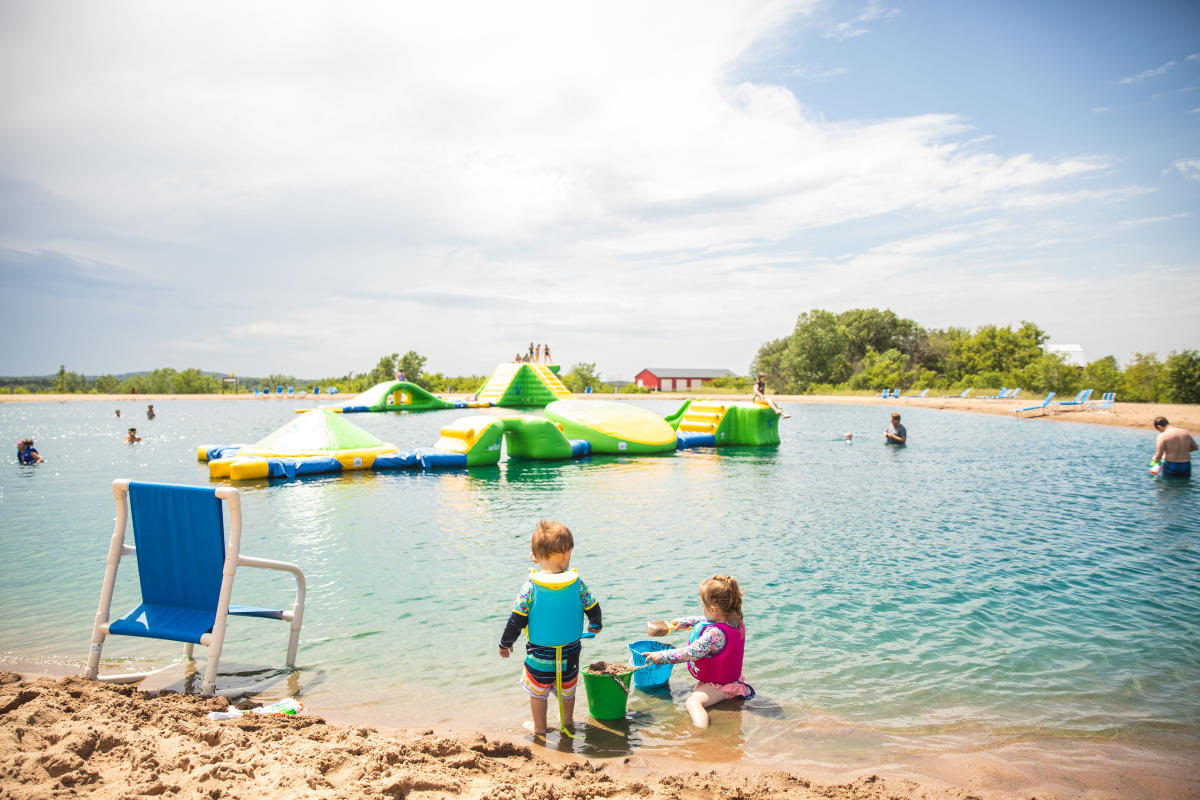 Kids playing in the sand and wibbit at Stoney Creek Resort in Osseo