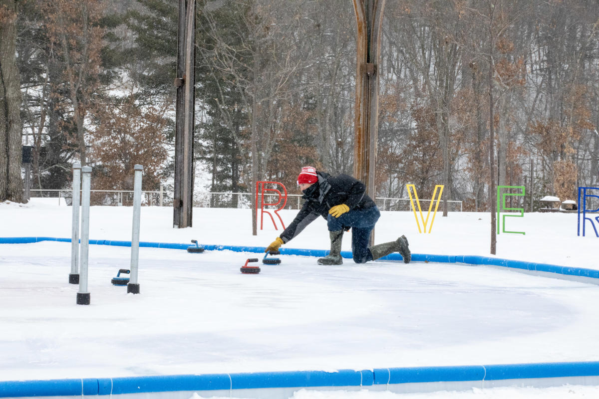 A man playing Crokicurl in the winter at River Prairie