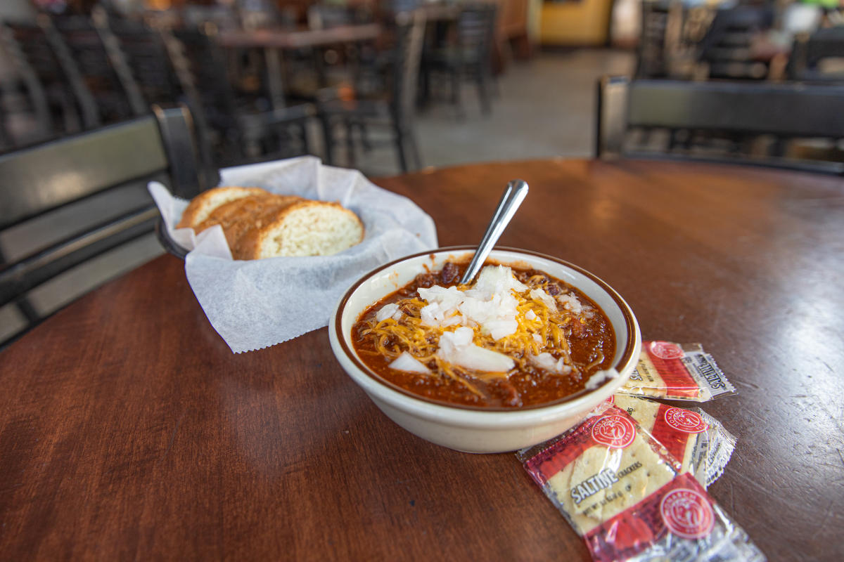 A bowl of loaded chili and a side of bread