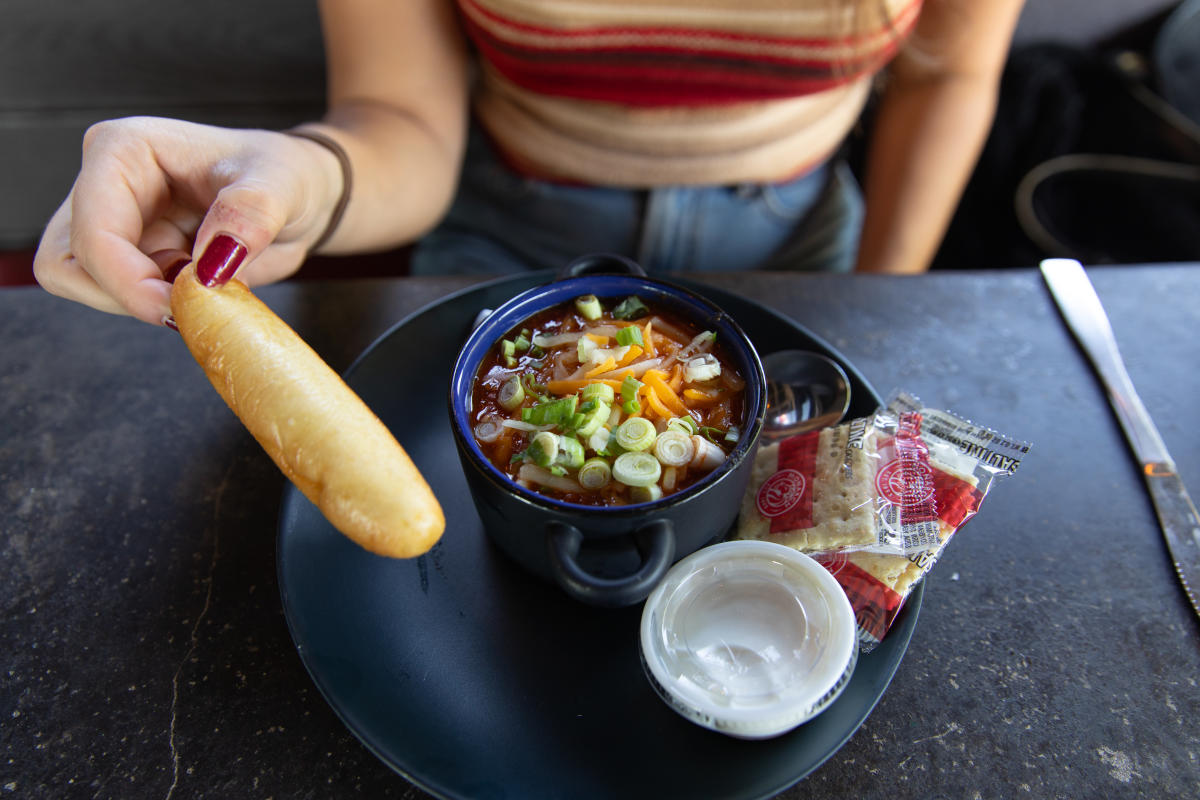 A girl with a bowl of loaded chili at Cowboy Jack's