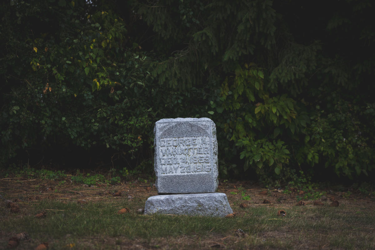a creepy photo of a tombstone at the haunted Asylum Hill in Eau Claire