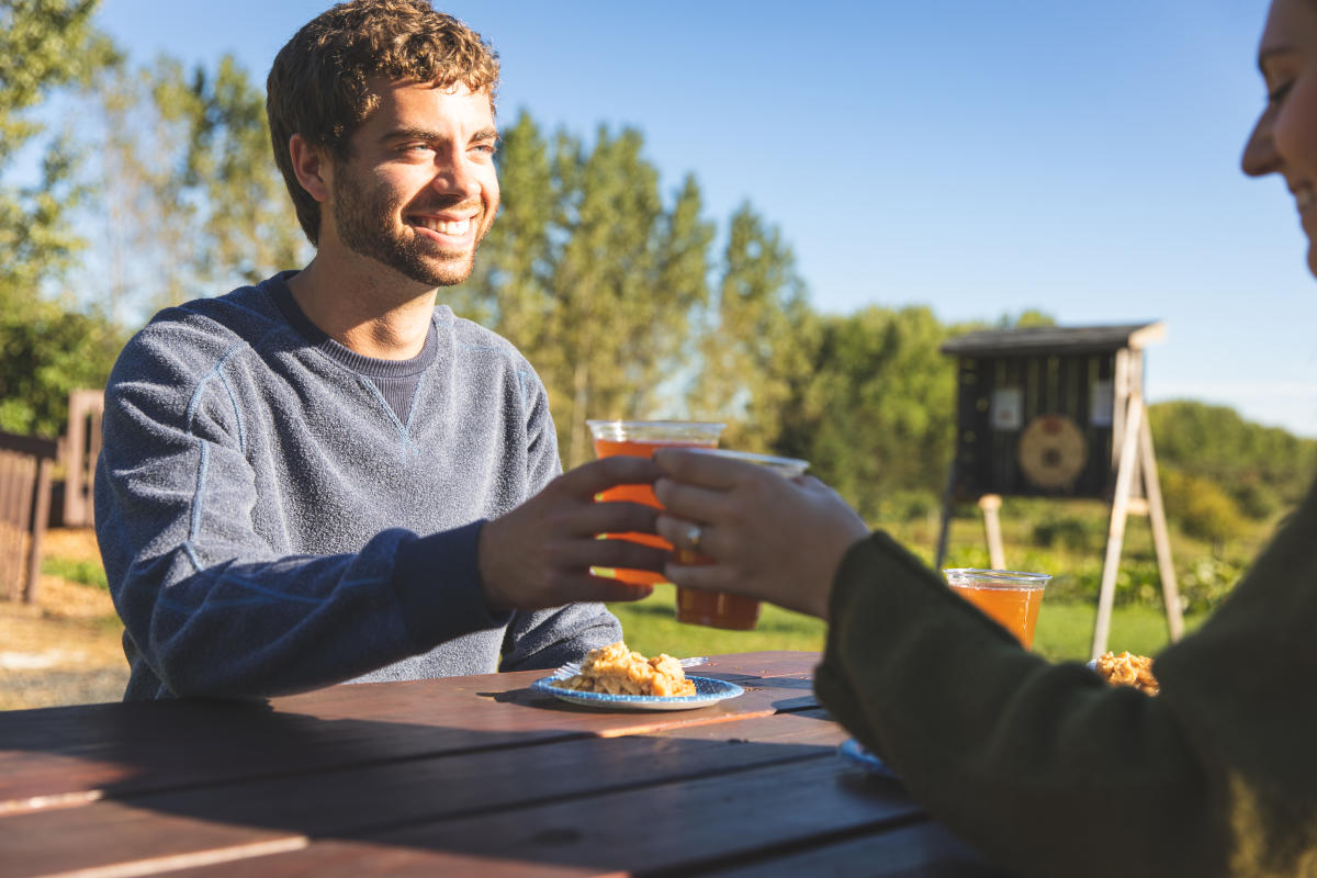 A man cheers his apple cider at Leffel Roots