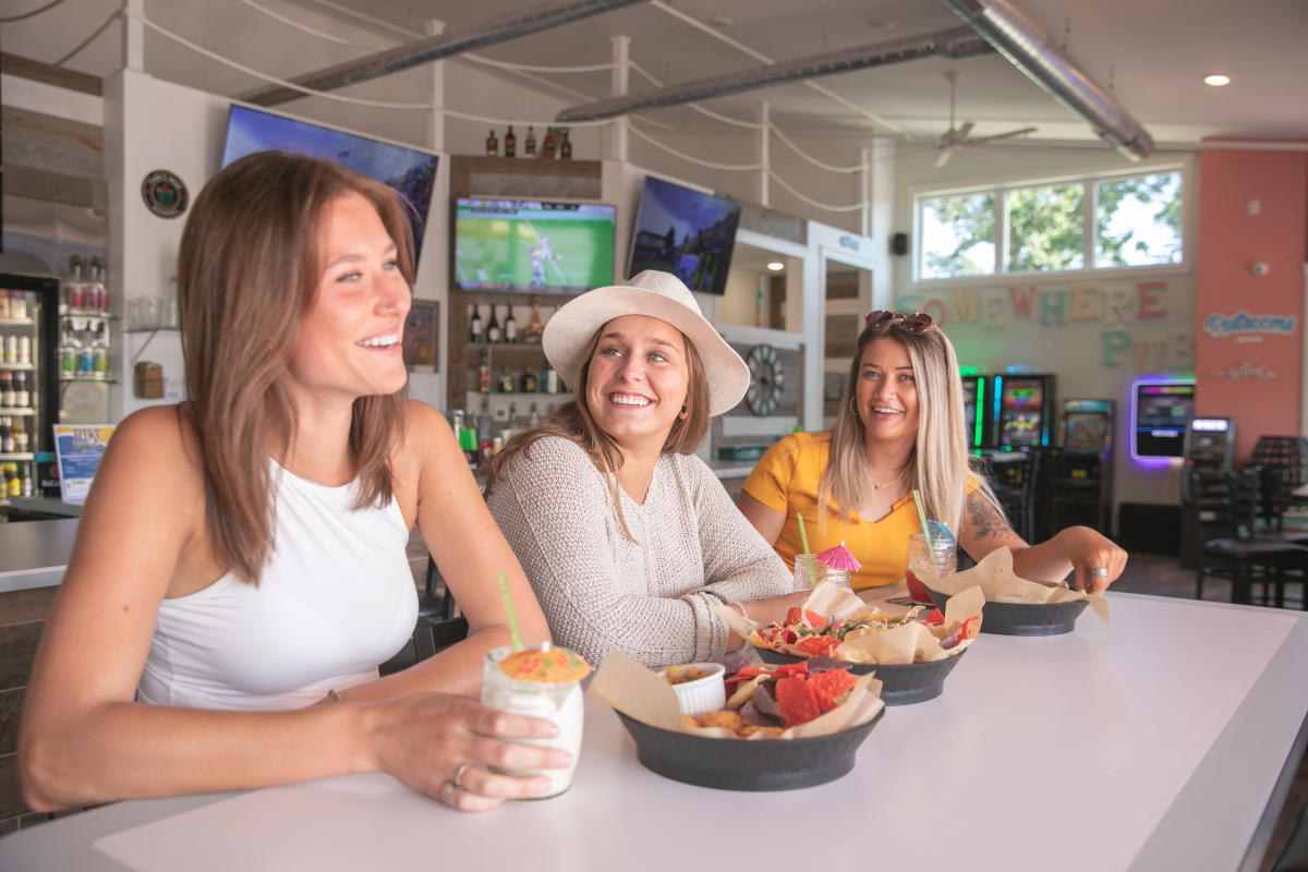 3 girls eating tropical appetizers at The Island Parkside in River Prairie in Altoona, WI