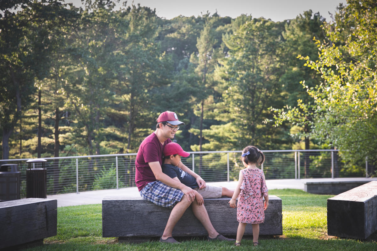 Dad and young daughter & son hanging out at River Prairie