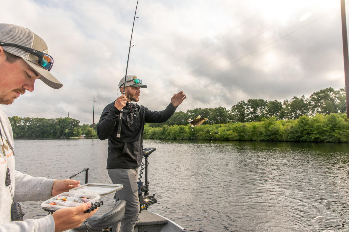 Two guys fishing off a boat on Lake Wissota