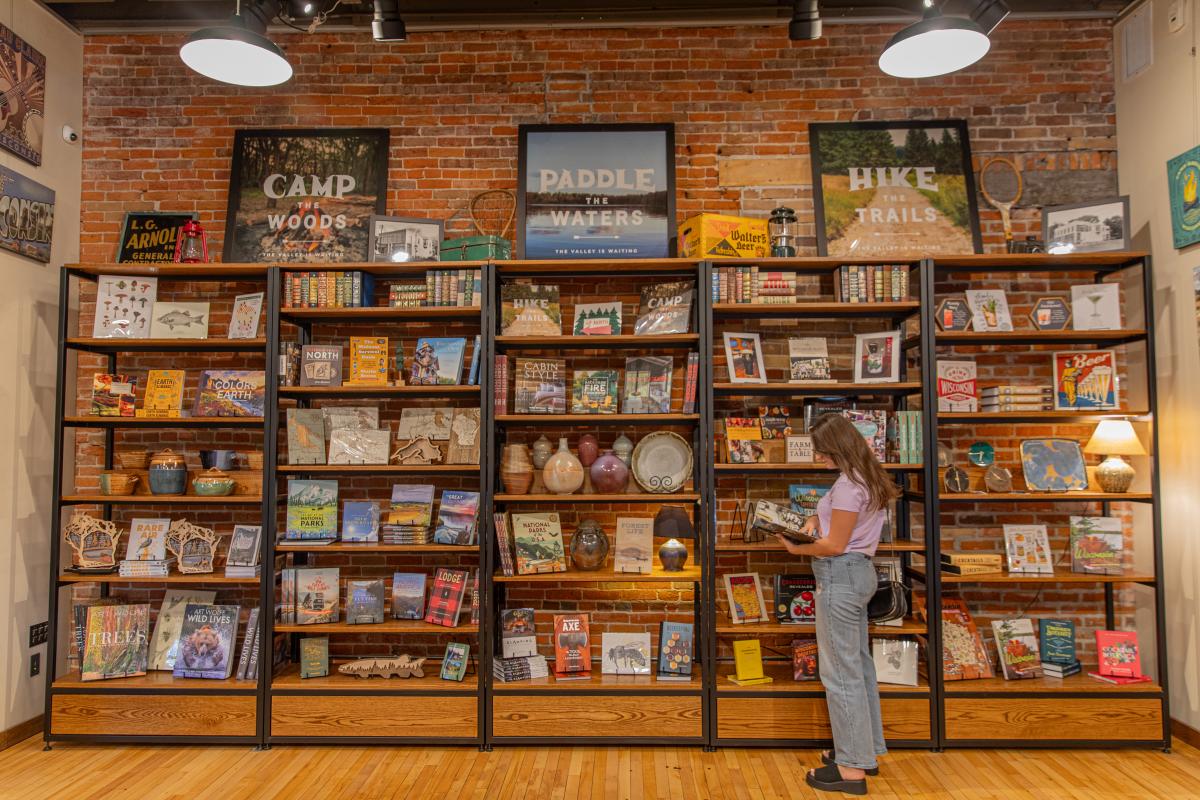 A girl looking at the bookshelves at The Local Store