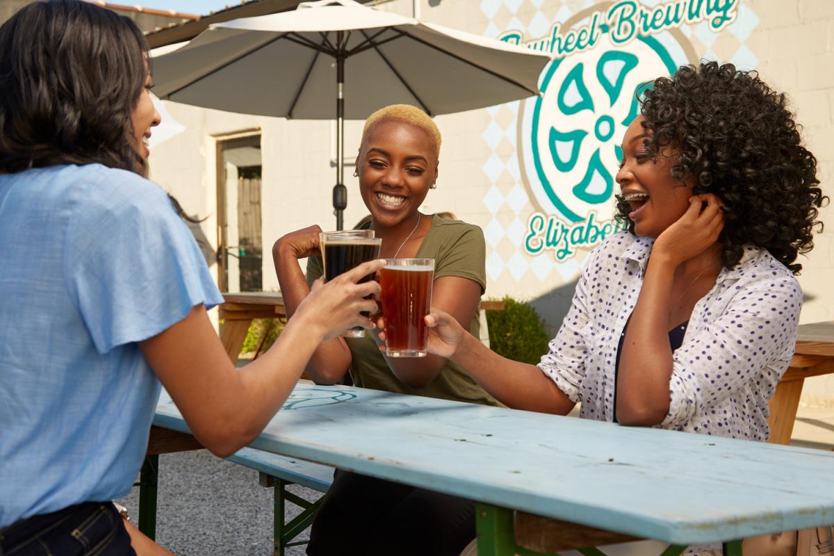 3 girls cheersing drinks at Flywheel Brewing