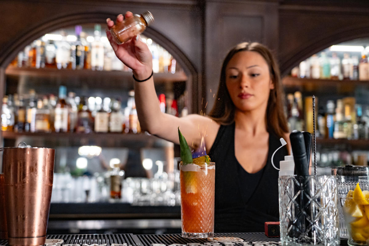 a bartender spicing up a drink at cavern club