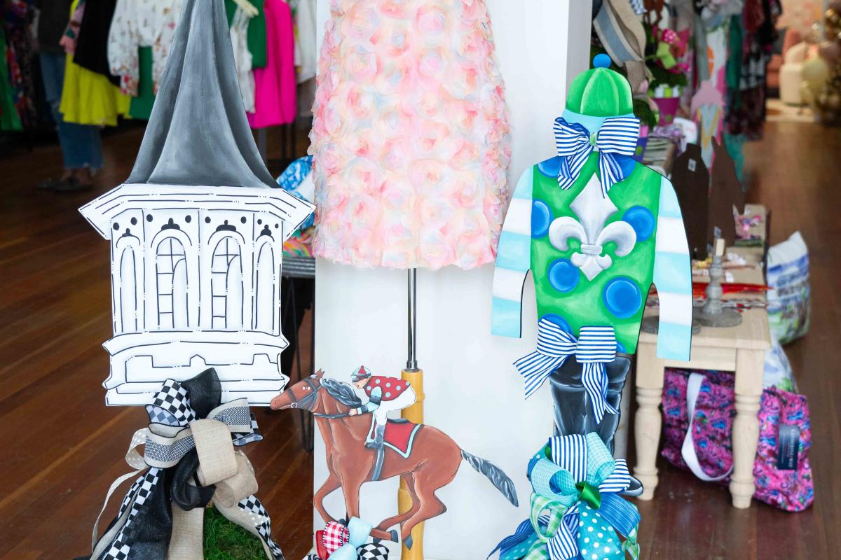 Mannequin with a Derby dress and matching flower hat with Derby decorations for potted plants in That Cute Little Shop