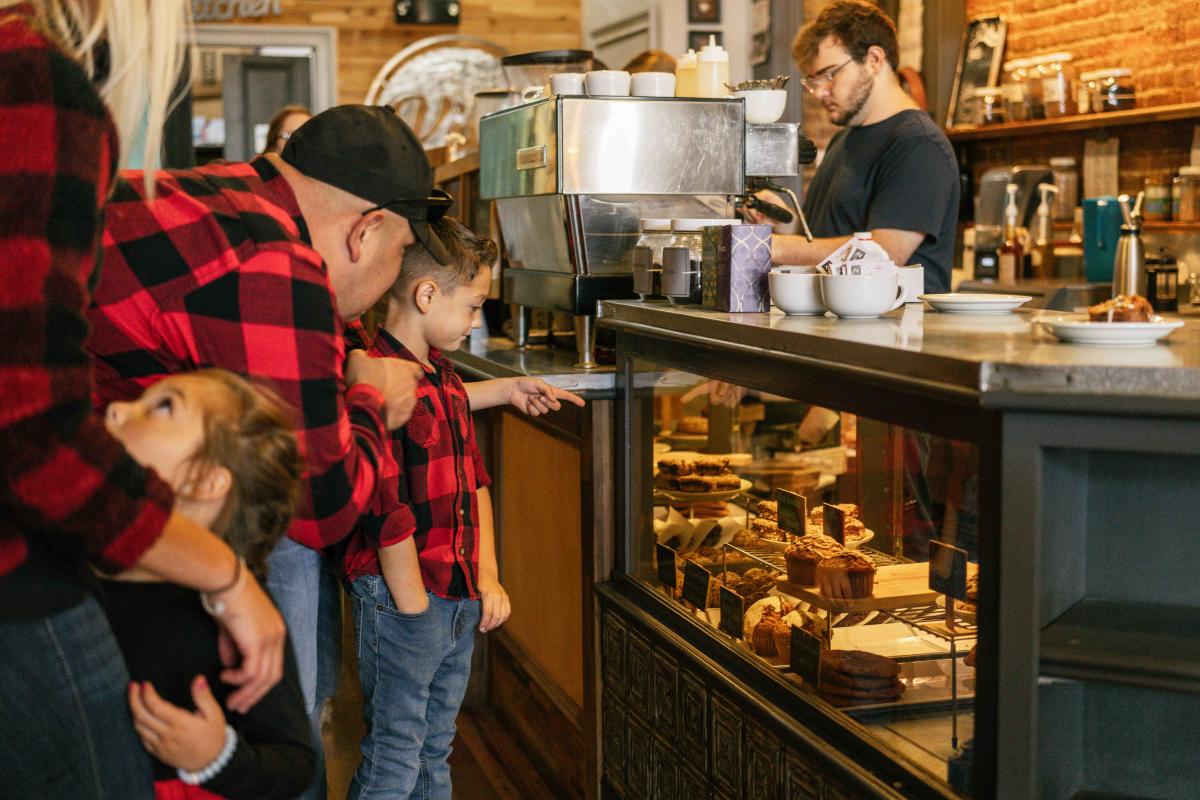 Dad and little kid pointing at the pastry display case in Vibe Coffee located in Downtown Elizabethtown