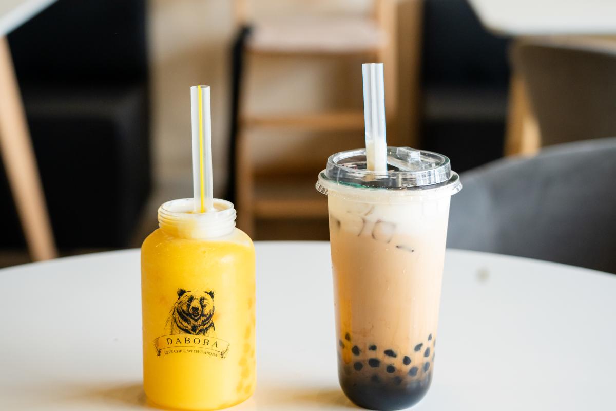 A yellow bubble tea and a brown sugar milk tea
