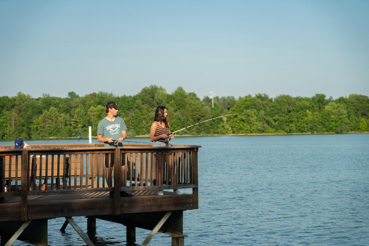 a couple fishing off the dock at freeman lake park