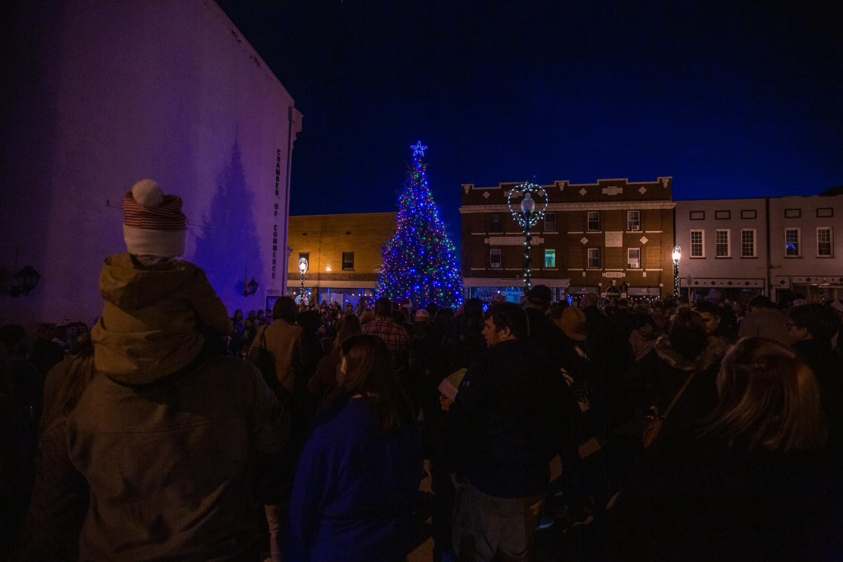 people gathered on the street in front of the christmas tree on walker square for light up downtown