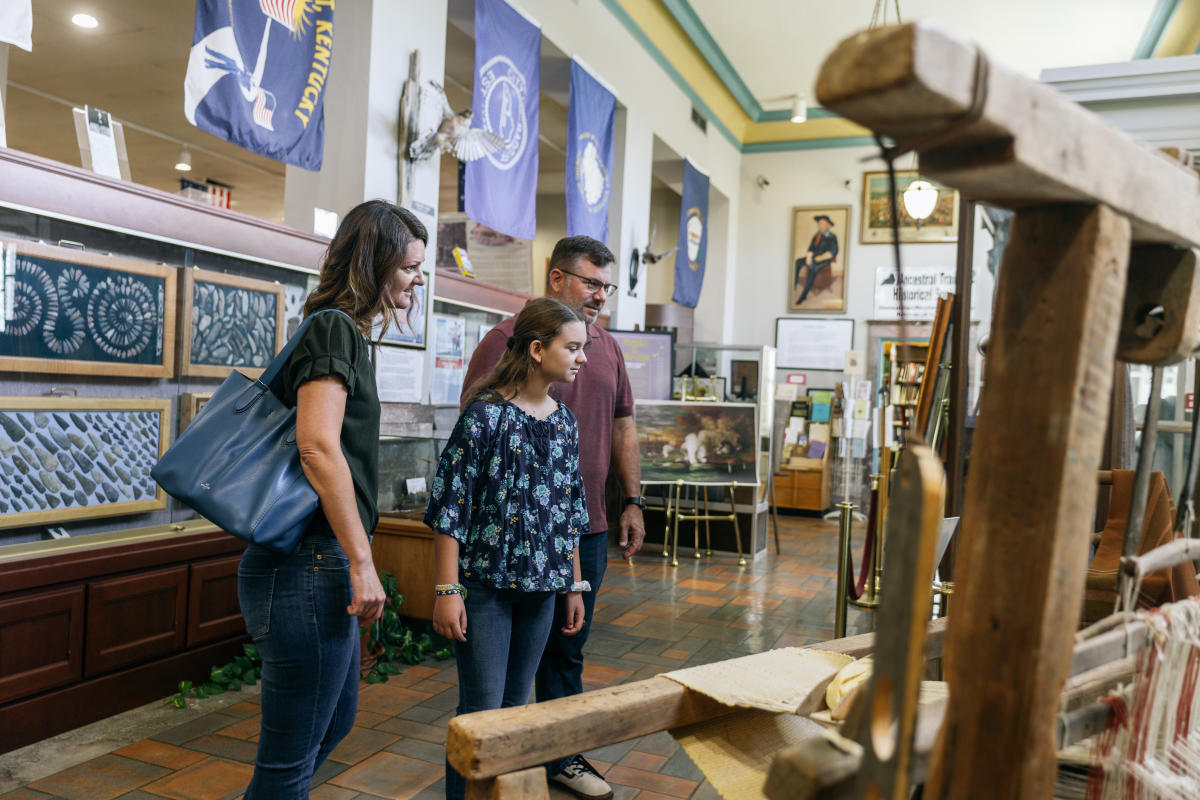 a family looking at artifacts at the hardin co. history museum