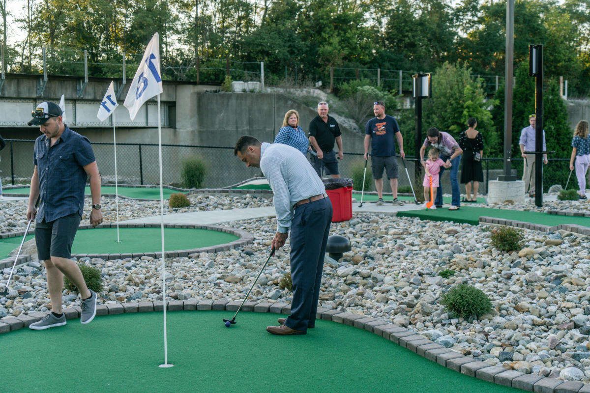 a man putting on a mini golf green at heartland mini golf