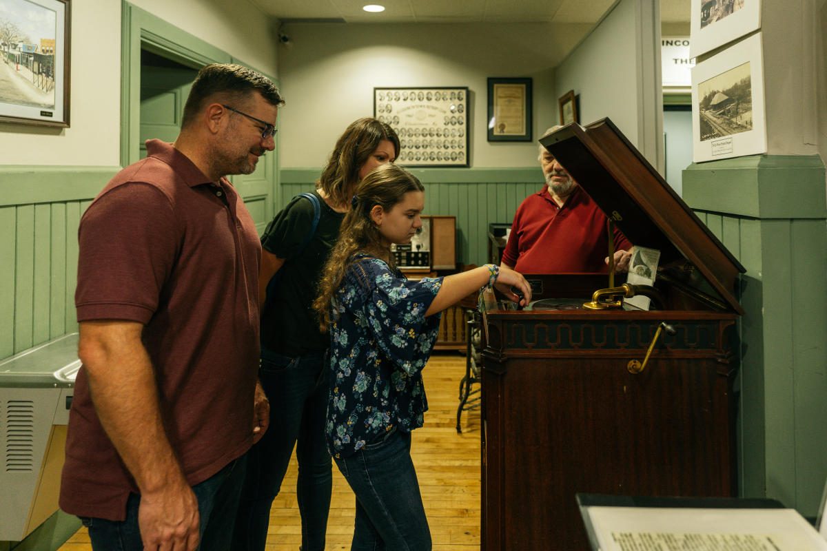 a family interacting with historical pieces at the hardin co. history museum