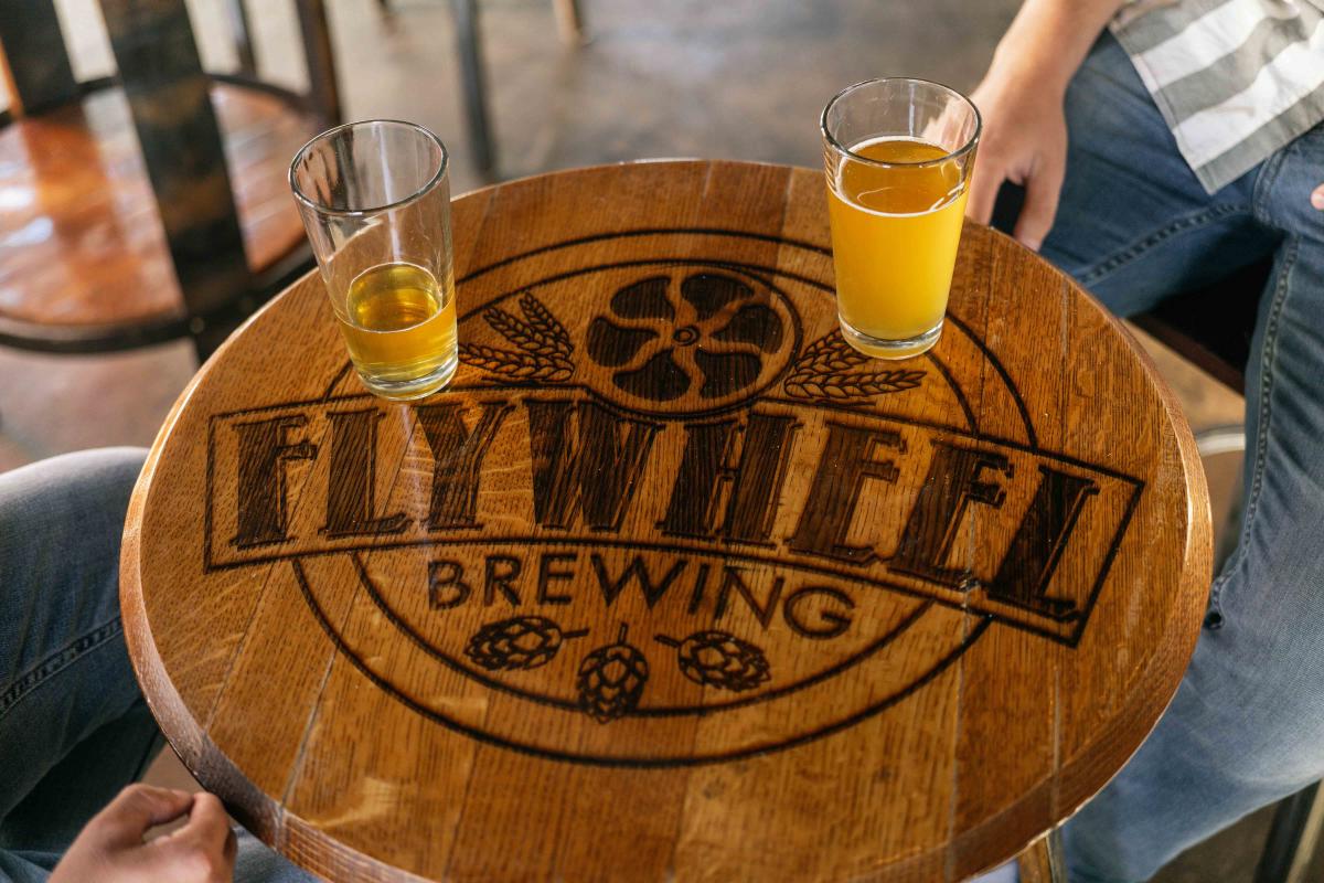 Two glasses of beer sitting on a Flywheel Brewing table inside of Flywheel Brewing in Elizabethtown, Kentucky
