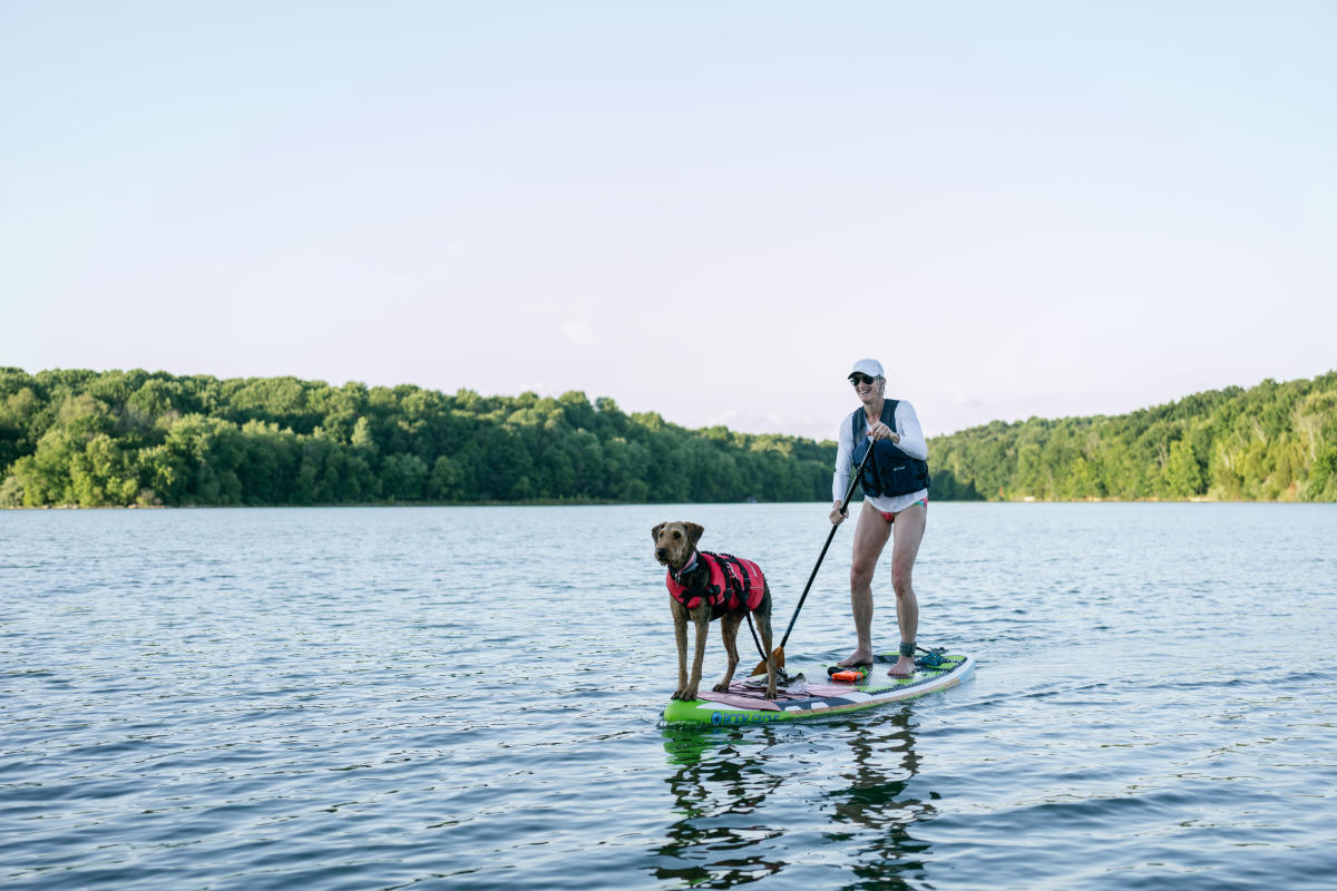 A girl paddle boarding with her dog at Freeman Lake Park