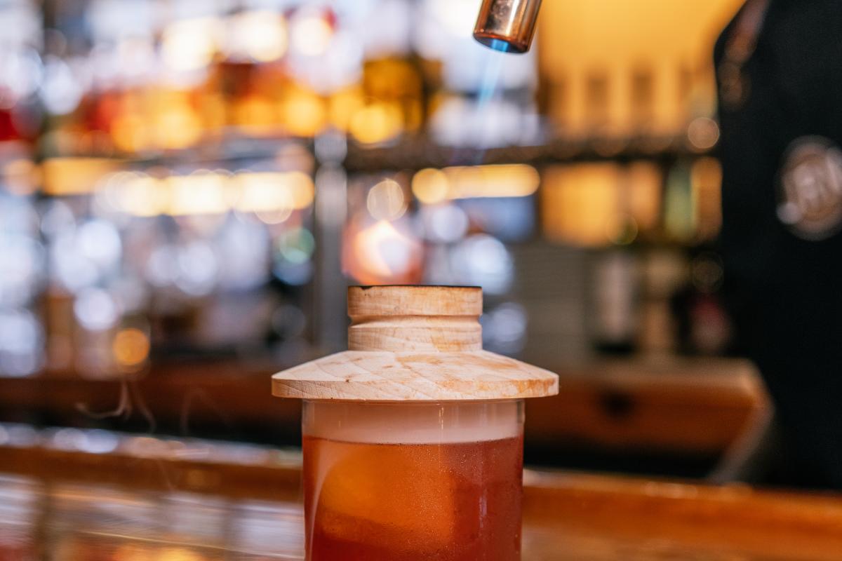 a bartender smoking an old fashioned at jr neighbors