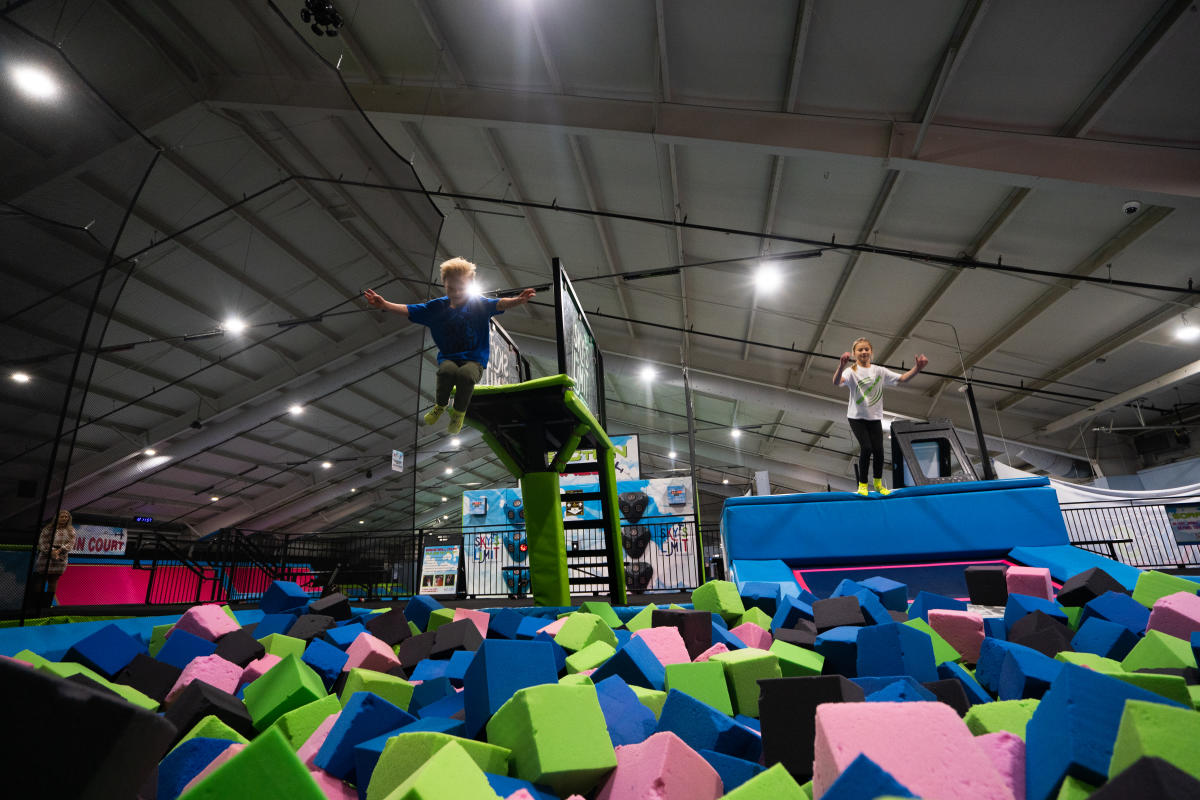 Two kids jumping into ball pit at Sky's the Limit